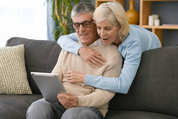 istock Older couple looking at their iPad 1404227051