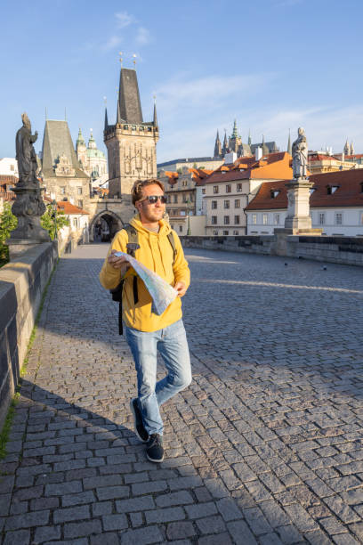 istock Young man solo traveler looking at city map 1404227626