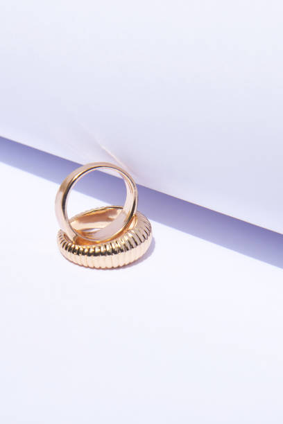 istock Two gold wedding rings on white background with contrasting shadows 1404227649