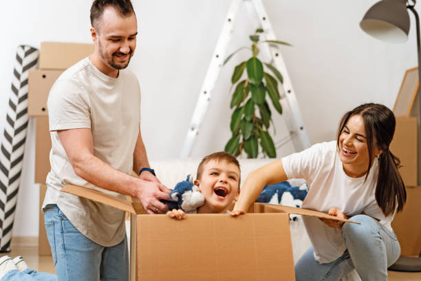 istock Parents and son packing boxes and moving into a new home 1404227687