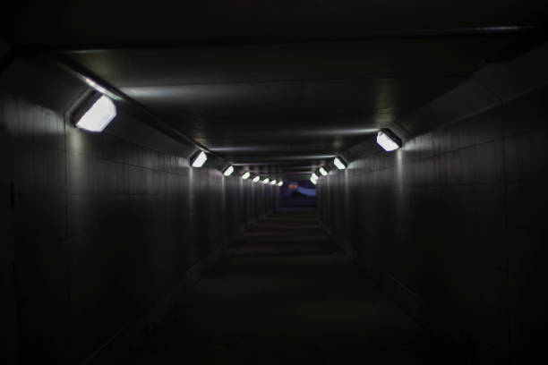 istock Gray tunnel with lamps. Electric light in hallway. 1404228202