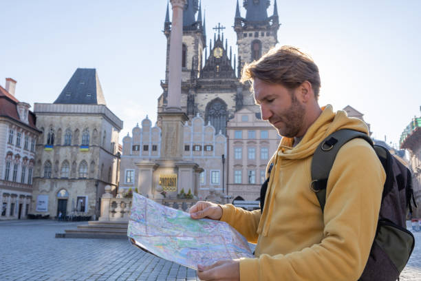 istock Young man solo traveler looking at city map 1404229120