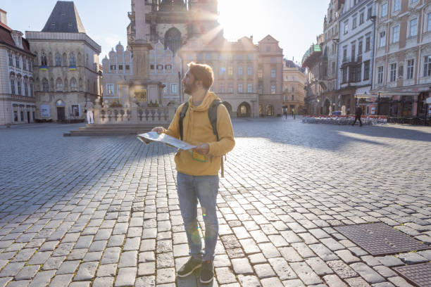 istock Young man solo traveler looking at city map 1404229170
