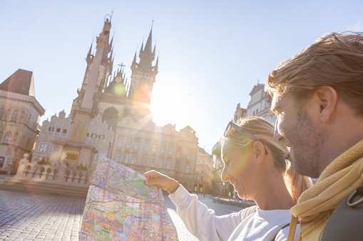 Young couple exploring the city and the famous landmark. 
Prague, Czech Republic