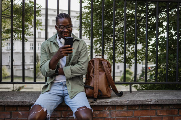 istock Young African American man looking at his smart phone 1404230895