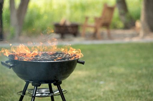 Barbecue grill in backyard with open flame