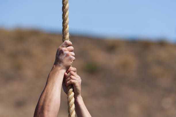 Special forces operative skilfully descending rope upside down in military training