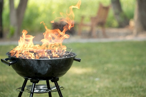 Barbecue grill in backyard with open flame