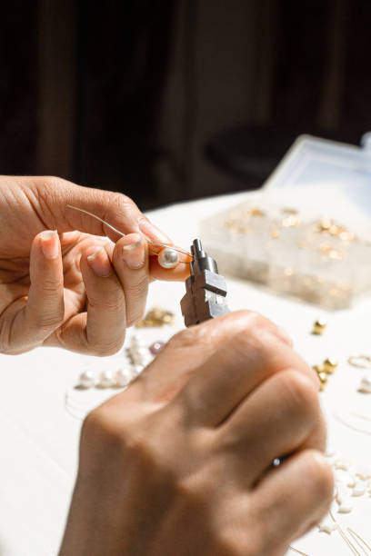 istock person using a round nose pliers on a metal wire, home crafts concept 1404235372