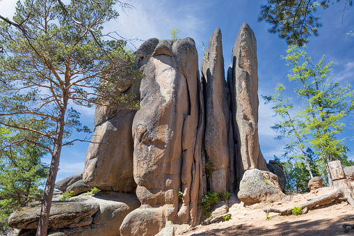 View on Feathers Stolb or Plumage Pillar rock in sunny summer day in the Stolby Nature Reserve in Krasnoyarsk, Russia