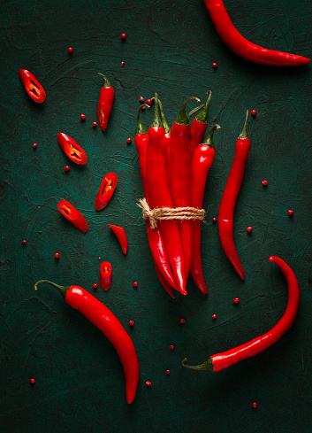 Bunch of red hot chili pepper, close-up, on a dark background, selective focus, no people, concept, food background, toned image.
