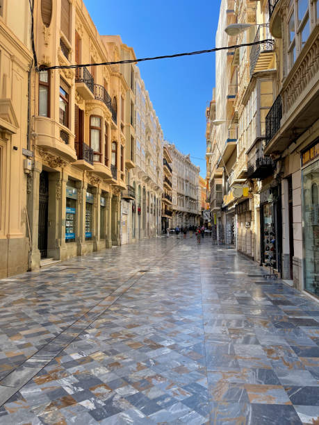 istock Old tittle downtown house area with an empty stone road under a clear sunny sky. 1404238520