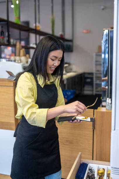 istock Woman holding cutlery standing at workplace 1404239143