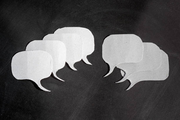 istock Pros and cons.Group of speech bubbles cut out of cardboard with multiple blank dialogue frames. 1404241622