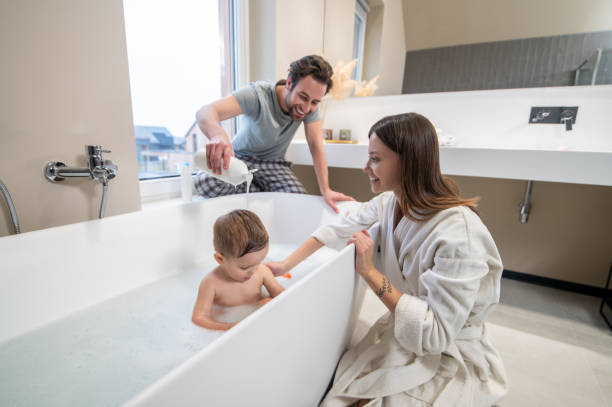 istock Woman and man bathing child in bathroom 1404241904