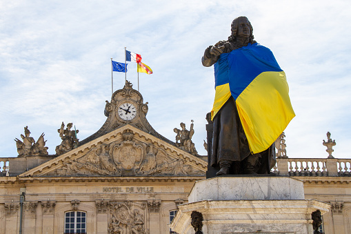 Nancy, France, April 18, 2022. Solidarity with Ukraine at war with Russia. Statue of Stanislas with the Ukrainian flag.