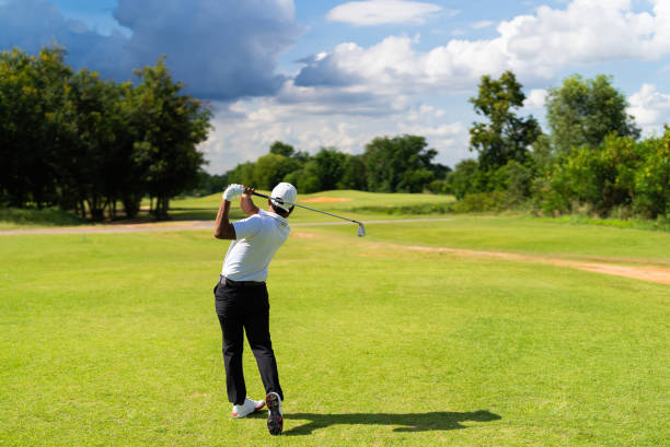 istock Asian man golfing on the course. In summer 1404245433