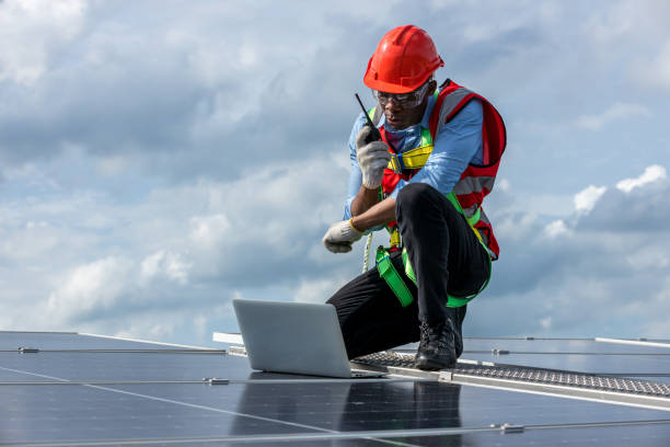 istock Engineer working setup Solar panel at the roof top. Engineer or worker work on solar panels or solar cells on the roof of business building 1404246446