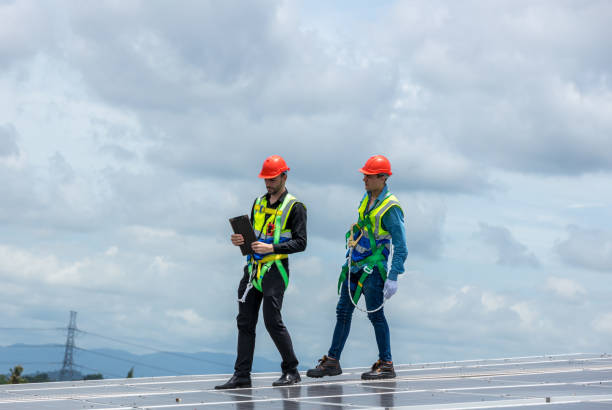 istock Team Engineer working setup Solar panel at the roof top. Team Engineer or Team worker work on solar panels or solar cells on the roof of business building 1404246462