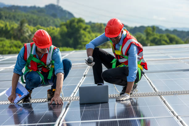 istock Team Engineer working setup Solar panel at the roof top. Team Engineer or Team worker work on solar panels or solar cells on the roof of business building 1404246474