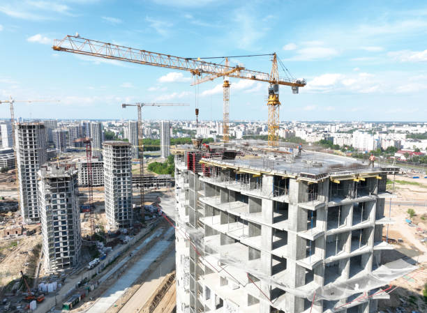 istock Cnstruction site with tower cranes on building construction. Builder on formworks. Cranes on pouring concrete in formwork. 1404247381