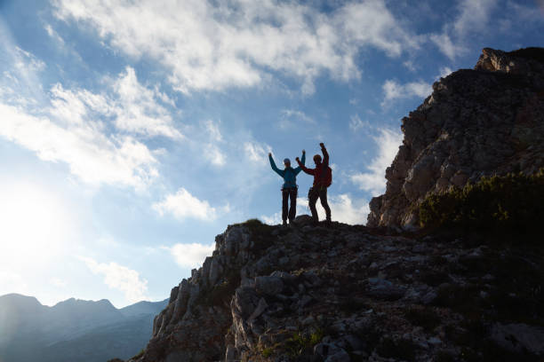 istock Rock climber with hands in the air 1404247472