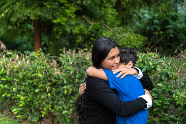 istock Two Latino brothers laughing and hugging each other in a park 1404249230