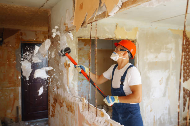 Repairer in hardhat  and boiler suit with tools. stock photo
