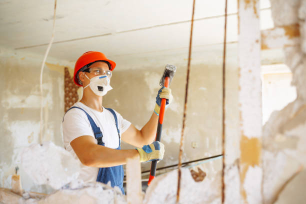 istock Repairer in hardhat  and boiler suit with tools. 1404250478