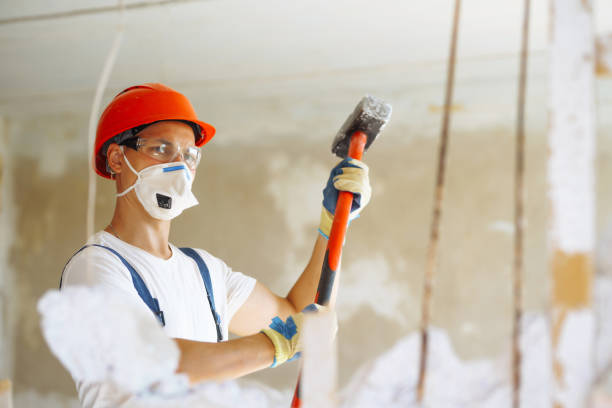 istock Repairer in hardhat  and boiler suit with tools. 1404250660