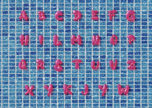 Alphabet set where the letters are inflated balloons floating on a swimming pool, as seen from above