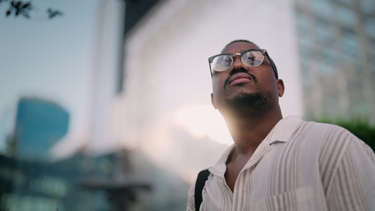 Portrait of young and handsome Black ethnicity businessman in city