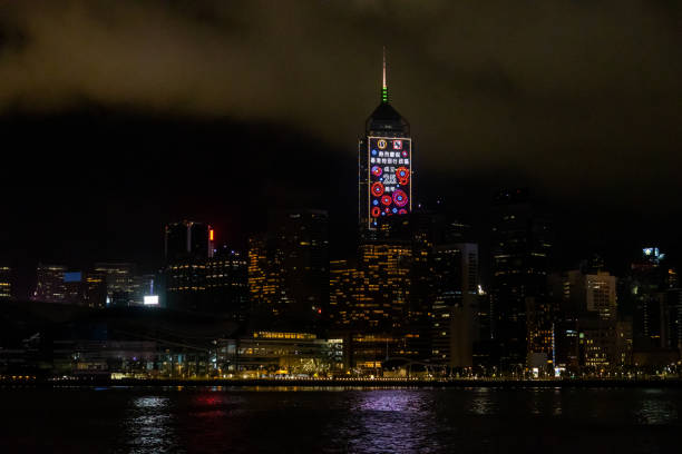 The 25th anniversary of Hong Kong's handover from Britain to China Hong Kong - June 21, 2022 : Building shows a slogan celebrating the upcoming 25th anniversary of Hong Kong's handover from Britain to China, in Hong kong. central plaza hong kong stock pictures, royalty-free photos & images