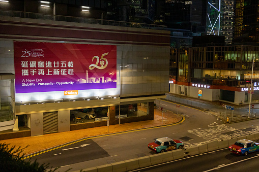 Hong Kong - June 21, 2022 : A banner with a slogan celebrating the upcoming 25th anniversary of Hong Kong's handover from Britain to China, in Hong Kong.