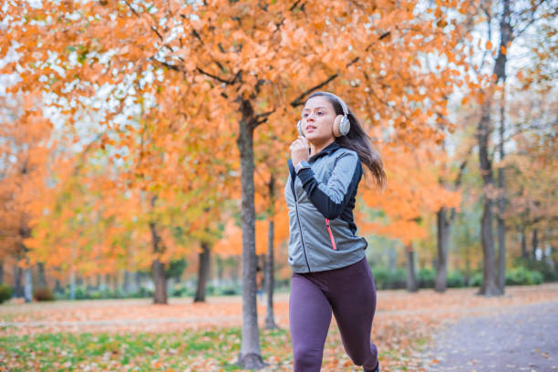 istock Woman running in autumn park 1404255982