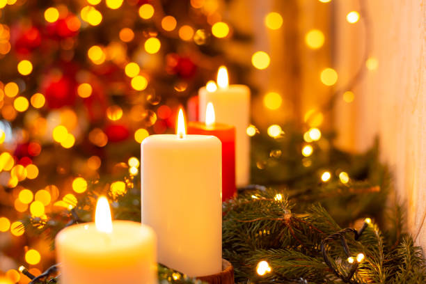 istock Burning candles on the background of christmas tree lights 1404259093