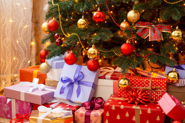 istock Beautiful christmas tree with many different presents beneath it 1404259130