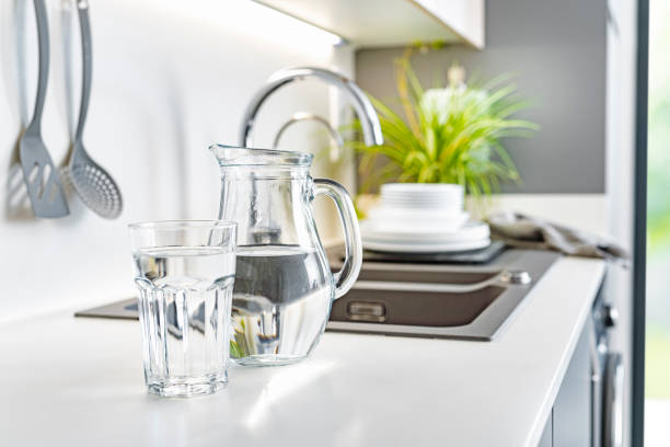 istock Water glass and pitcher on kitchen counter 1404260494
