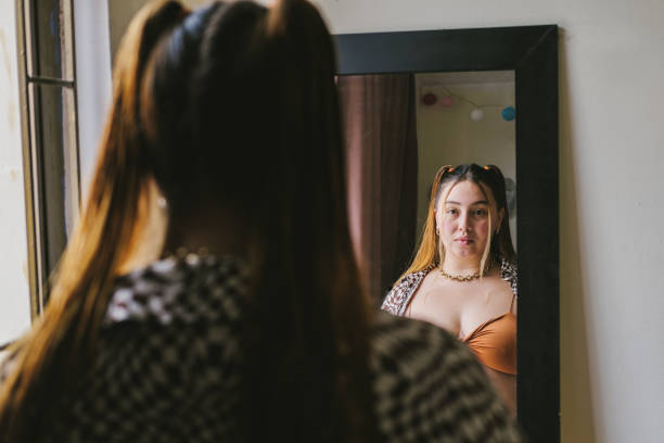 istock Woman putting on makeup 1404262380