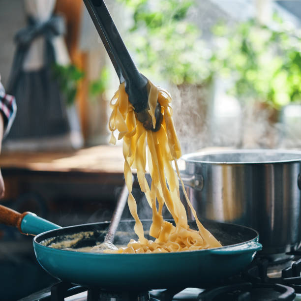 istock Preparing Fettuccine Pasta Alfredo with Parmesan 1404262476