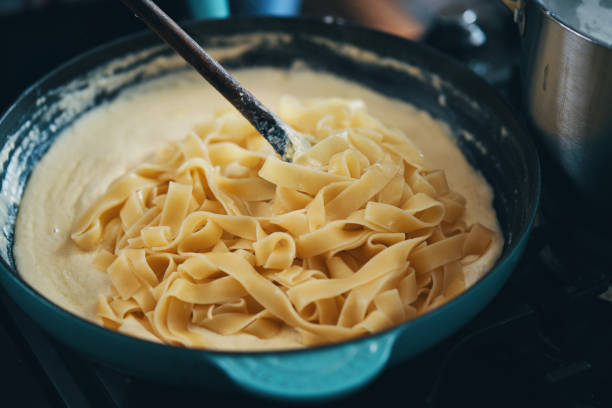 istock Preparing Fettuccine Pasta Alfredo with Parmesan 1404262487