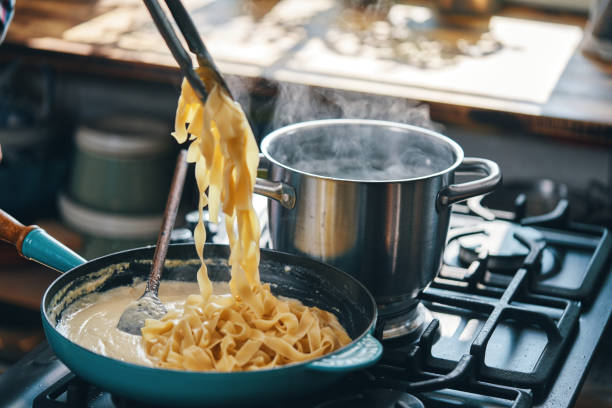 istock Preparing Fettuccine Pasta Alfredo with Parmesan 1404262499