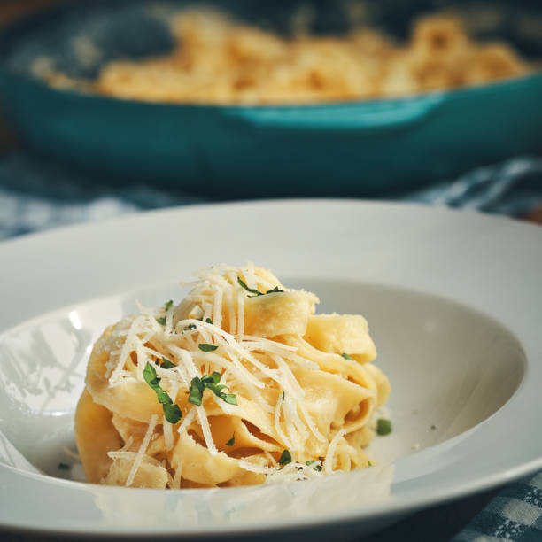 istock Preparing Fettuccine Pasta Alfredo with Parmesan 1404262521