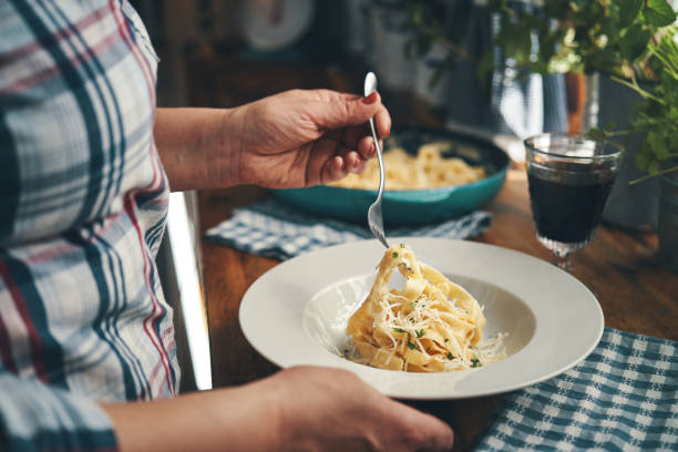istock Preparing Fettuccine Pasta Alfredo with Parmesan 1404262568