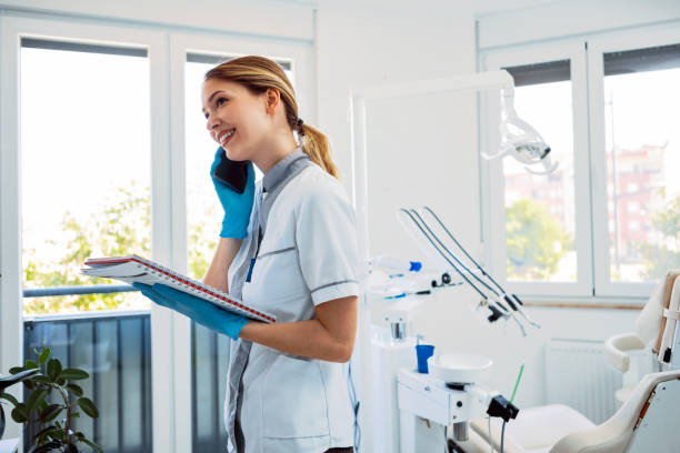 istock Confident young woman working in a dentist’s office talking on smart phone 1404268068