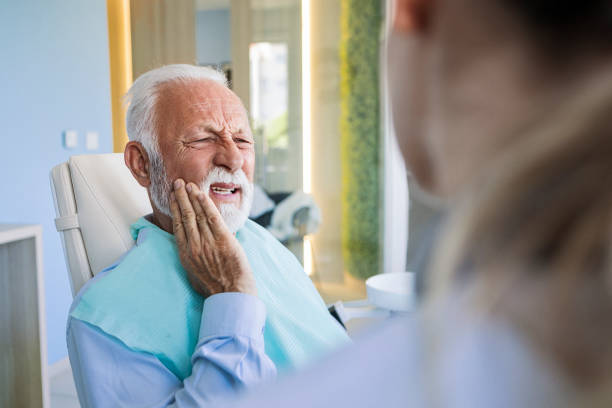 istock Senior man at dentist making painful face 1404268078
