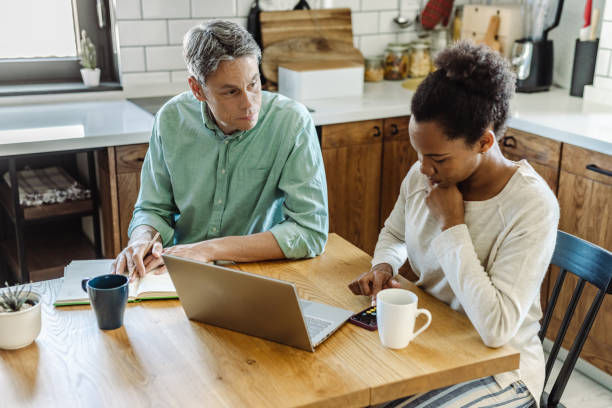 istock Couple going through bills, looking worried 1404268254