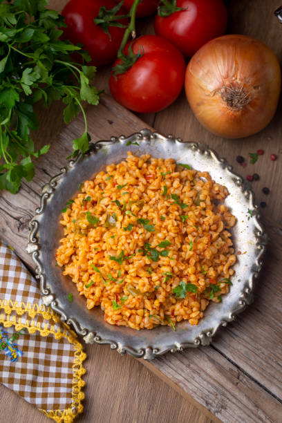 istock Traditional turkish bulgur pilaf with tomato sause in plate (Turkish name; meyhane pilavi) 1404269368