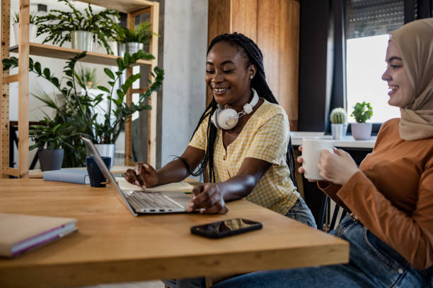istock Two young women using laptop at home 1404270306