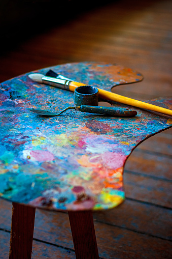 Colorful artist's palette with brushes and oil paints